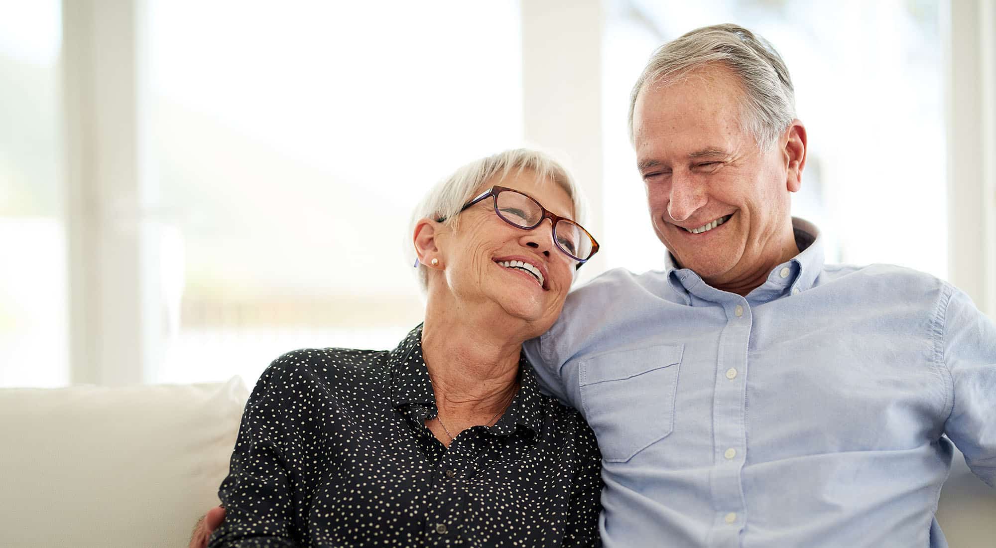 A happy couple who just sold a universal life insurance policy for cash