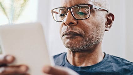 A man reading about selling his life insurance policy with Lighthouse Life