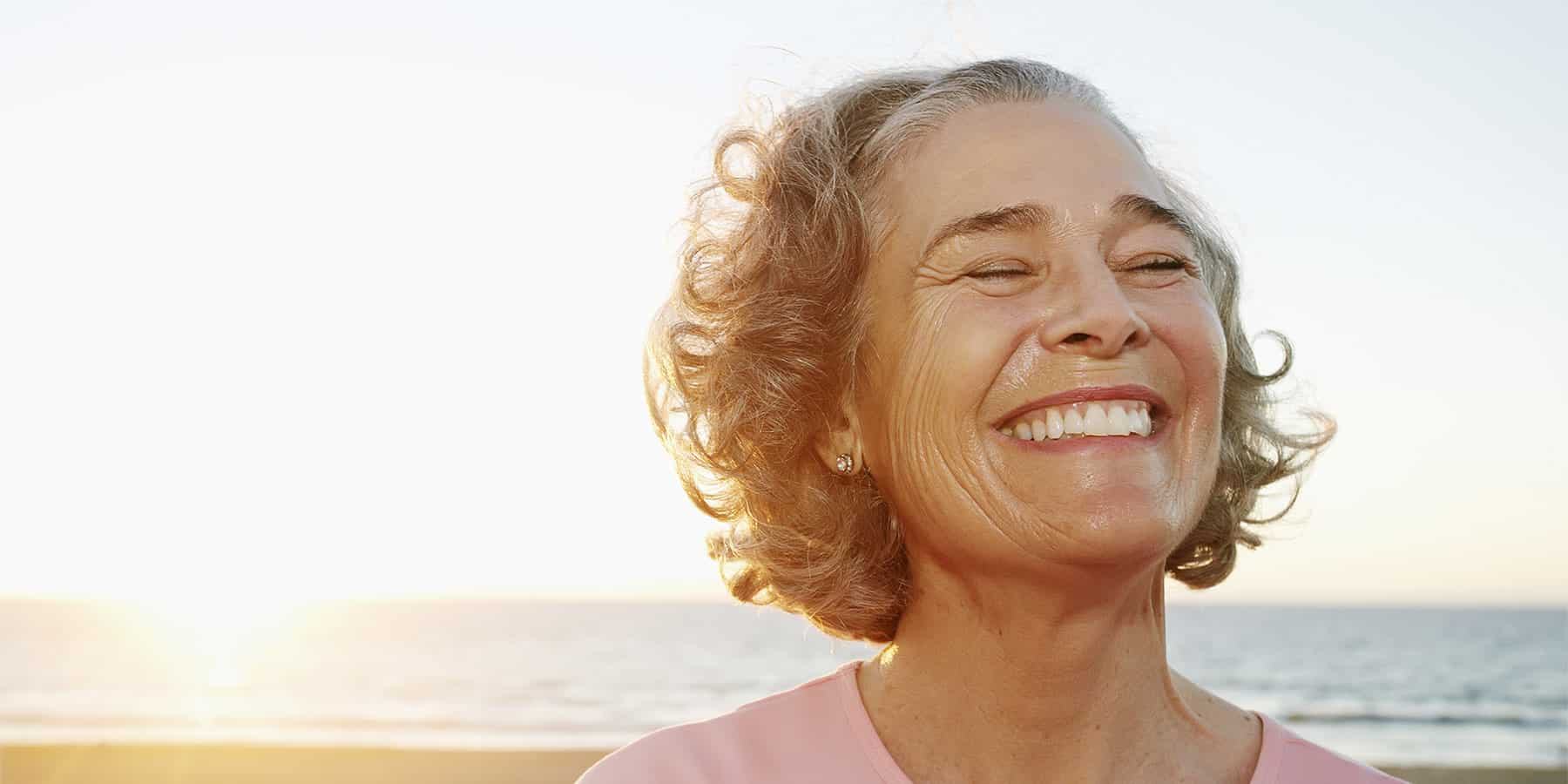 A woman who is happy because her life settlement is worth more than her policy's cash surrender value.