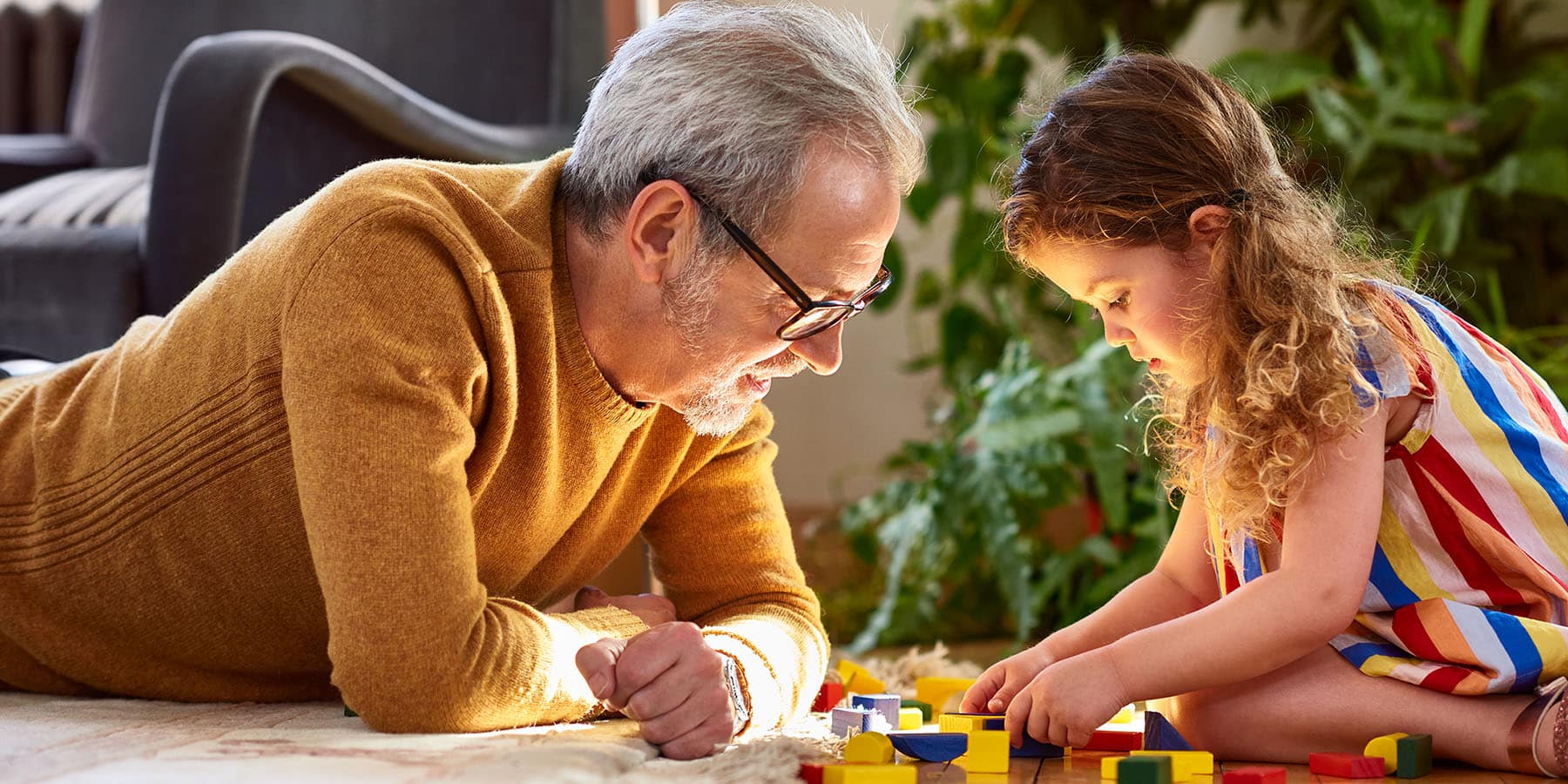 A retired grandfather playing with his granddaughter