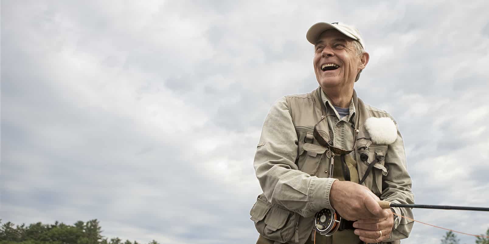 an older American fly fishing after a life settlement