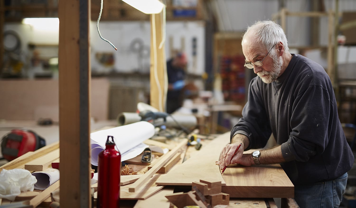 A senior man enjoying time in his wordworking shop